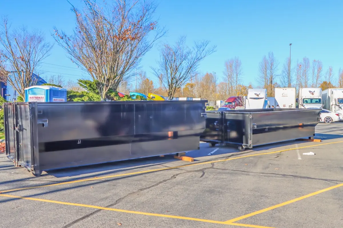 Professional dumpster rental service with roll-off container on residential driveway in Old Lyme